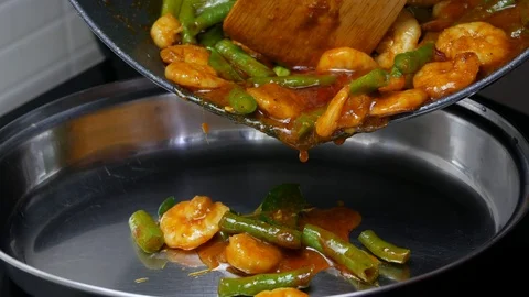 Pour stir fried yard long beans with shrimp , kaffir lime leaves, spices curr Stock Footage 89493985