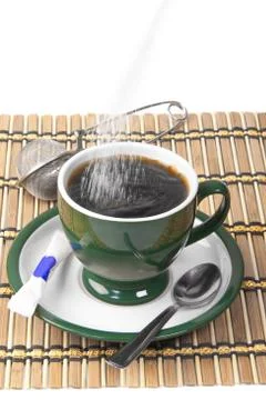 Pour sugar into a mug Stock Photos