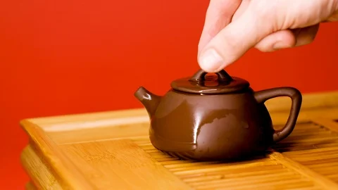 Pour tea into a clay teapot on a shepherd Stock Footage 127440675