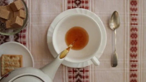 Pour tea into a cup overhead shot Stock Footage 72679883