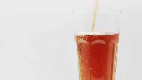 Pour Tea into a rotating glass on a white background.. Stock Footage 196065390