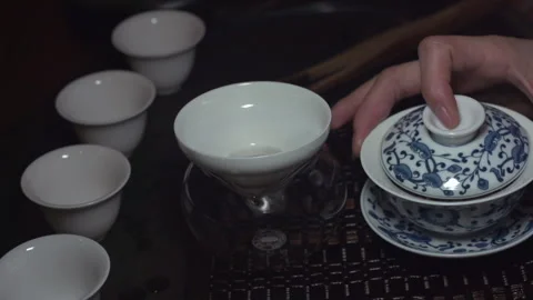 Pour tea into a tea bowl Stock Footage 278962715