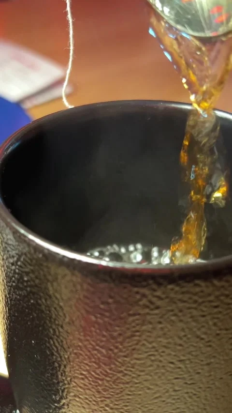 Pour tea Tea with herbs and berries is poured into a transparent tea cup. Stock Footage 294531129