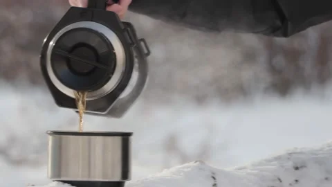 Pour tea from a thermos in the cold in winter Stock Footage 233920736