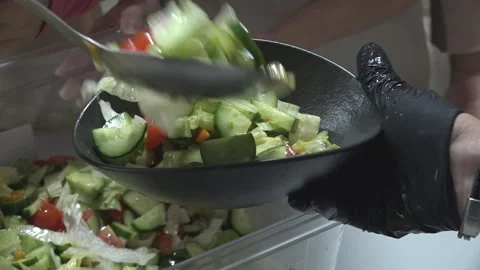 Pour the vegetable salad into a plate Stock Footage 318241352