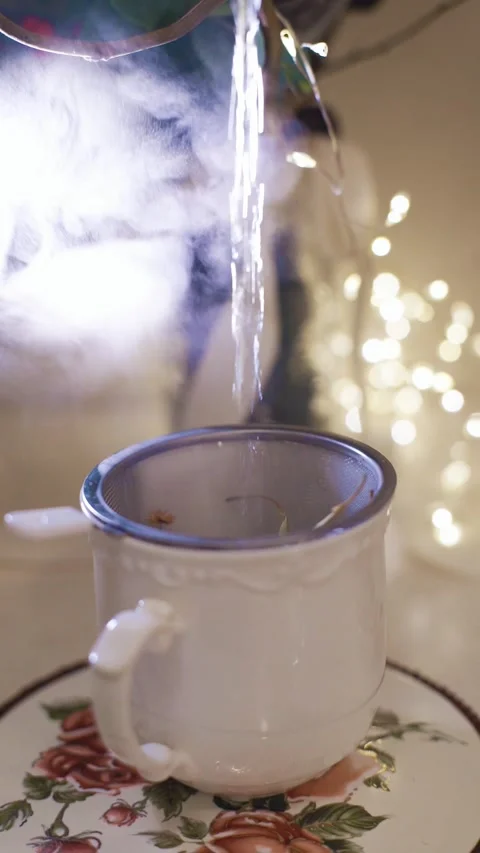 Close-up view of pouring hot tea from thermos into cup Stock Photo