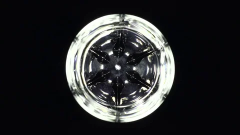 Pour water into a lighted glass Stock Footage