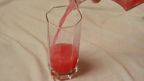 Pour the watermelon juice into a clear glass. Stock Footage 140771253