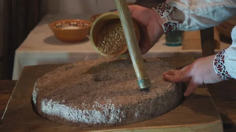 Pour wheat grain into an old mill Stock Footage 145375405