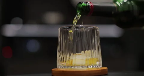 Pour whiskey into glass on background. Stock Footage 296418922