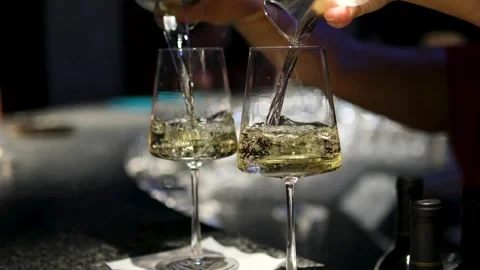 Pour white wine into glasses from both sides at the same time Beautiful View Of 動画素材 318382864
