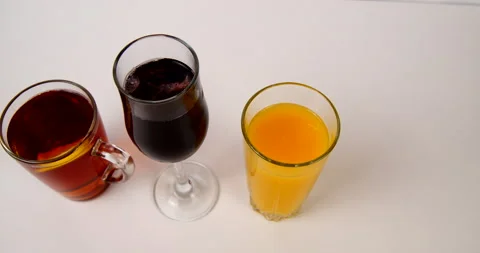 Poured drinks in glasses tea and juice Stock Footage 143121355