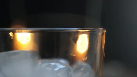 Poured into a glass with ice from a bottle, bartender, close-up Stock Footage 137790329