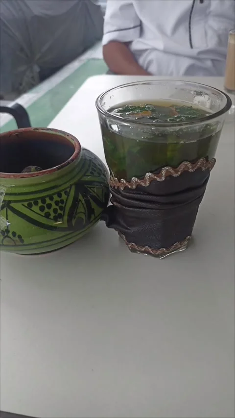 Pouring and Serving Traditional Moroccan Mint Tea at Local Cafe Stock Footage 342563410
