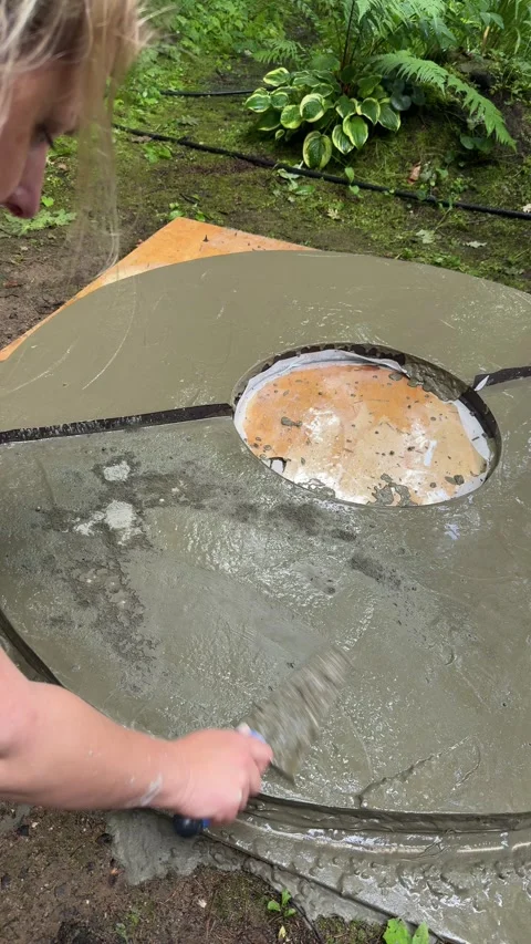 Pouring and Spreading Concrete in a Round Mold for DIY Fire Pit Table Stock Footage 342002244
