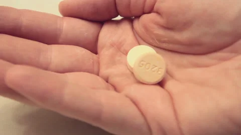 Pouring Antacid into Hand Stock Footage 34480507