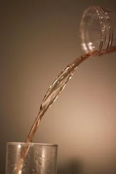 Pouring apple juice in a glass 库存照片