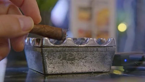 Pouring ashes into ashtray with cigar in hand Stock Footage 331256015