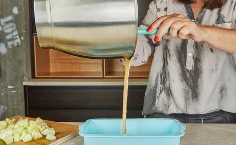 Pouring batter into baking pan Stock Photos
