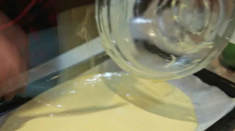 Pouring batter into a large baking dish Stock Footage 58141304