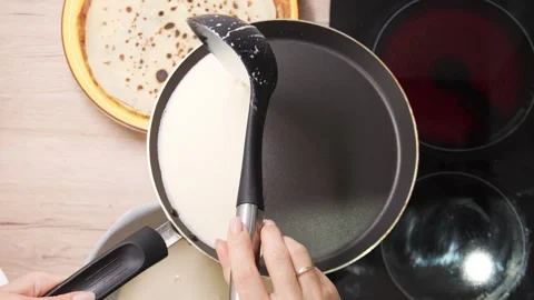Pouring batter onto a skillet. Stock Footage 256237950