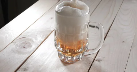 Pouring beer with bubbles and foam in glass Stock Footage 140214504