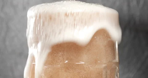 Pouring beer with bubbles and foam in glass Stock Footage 140215387