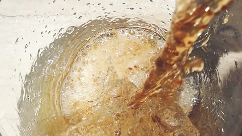 Pouring Beer Close-Up with Foam and Bubbles in Glass Stock Footage 346087949