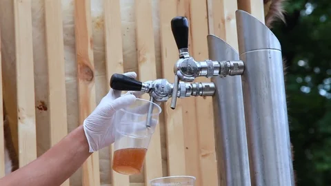 Pouring beer into plastic cup Stock Footage 107533893