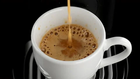 Pouring black coffee stream from machine in cup Stock Footage 159589014