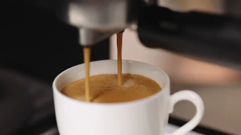Pouring black coffee stream from machine in cup. Making hot Espresso. Automatic Stock Footage 194794824