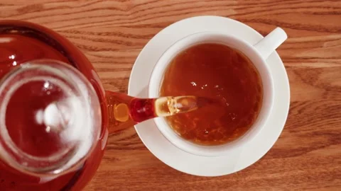 Pouring black tea into cup top view. Freshly brewed green tea ceremony process Stock Footage 190879216