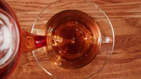 Pouring black tea into cup top view. Freshly brewed green tea ceremony process Stock Footage 190879542
