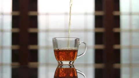 Pouring black tea 스톡 동영상 143785375