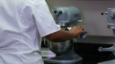 Pouring blue dye in stand mixer by baker Stock Footage 106944993