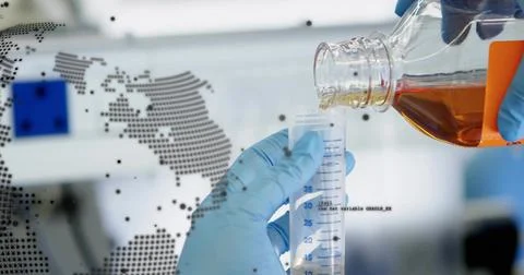 Pouring blue-gloved tech adding amber reagent into cyl blue-mark at bench, map Stock Photos