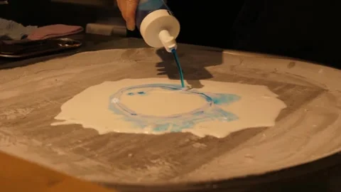 Pouring Blue Syrup onto Liquid Ice Cream Base on a Cold Pan Machine 動画素材 345293272
