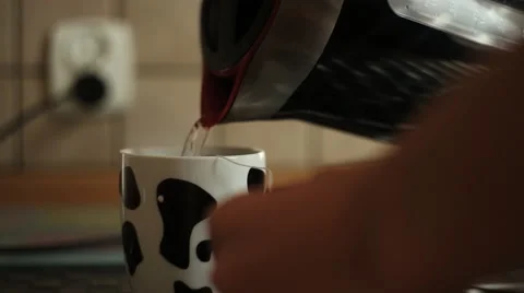 Pouring boiling water into a cup, brew tea Video stock 42179523