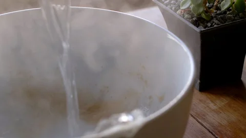 Pouring boiling water into large white bowl with tea spices 스톡 동영상 105629121