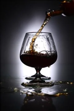 Pouring brandy into a glass Stock Photos