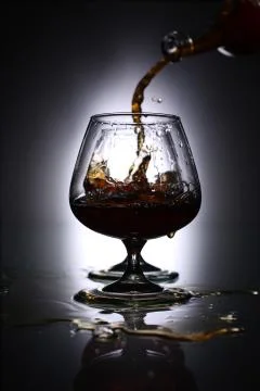 Pouring brandy into a glass Foto stock