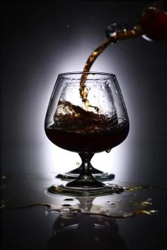 Pouring brandy into a glass Stock Photos