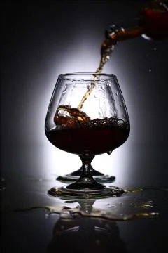 Pouring brandy into a glass Stock Photos