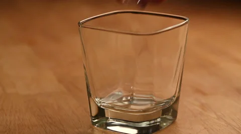 Pouring brandy with ice cubes Stock Footage 28318857