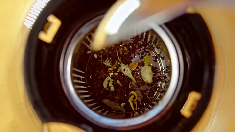 Pouring brew into teapot on table Stock Footage 156942364