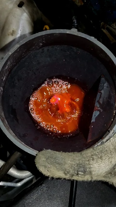 Pouring bright red coolant from blue bucket into black funnel Stock Footage 337179539