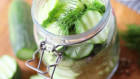 Pouring brine over cucumbers Stock Footage 79228362