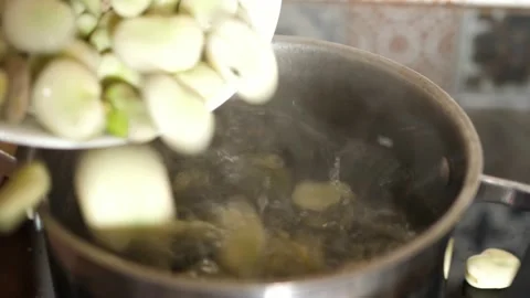 Pouring broad beans into a pot of boiling water Stock-Footage 136948545