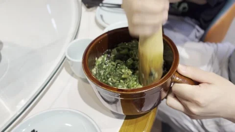 Pouring Broth Over Chopped Greens in a Bowl Vídeo Stock 343877552