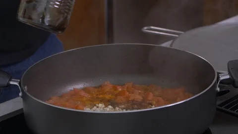 Pouring Brown Liquid Into Pan Stock Footage 97658902